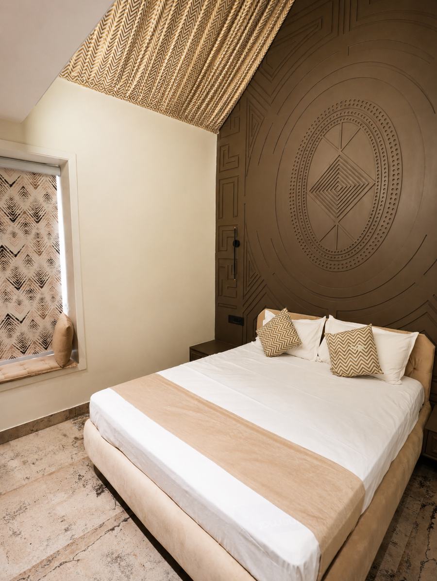 Sand-toned room with a carved mandala wall