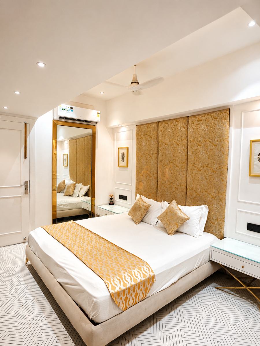 Gold padded headboard with brass lattice panels